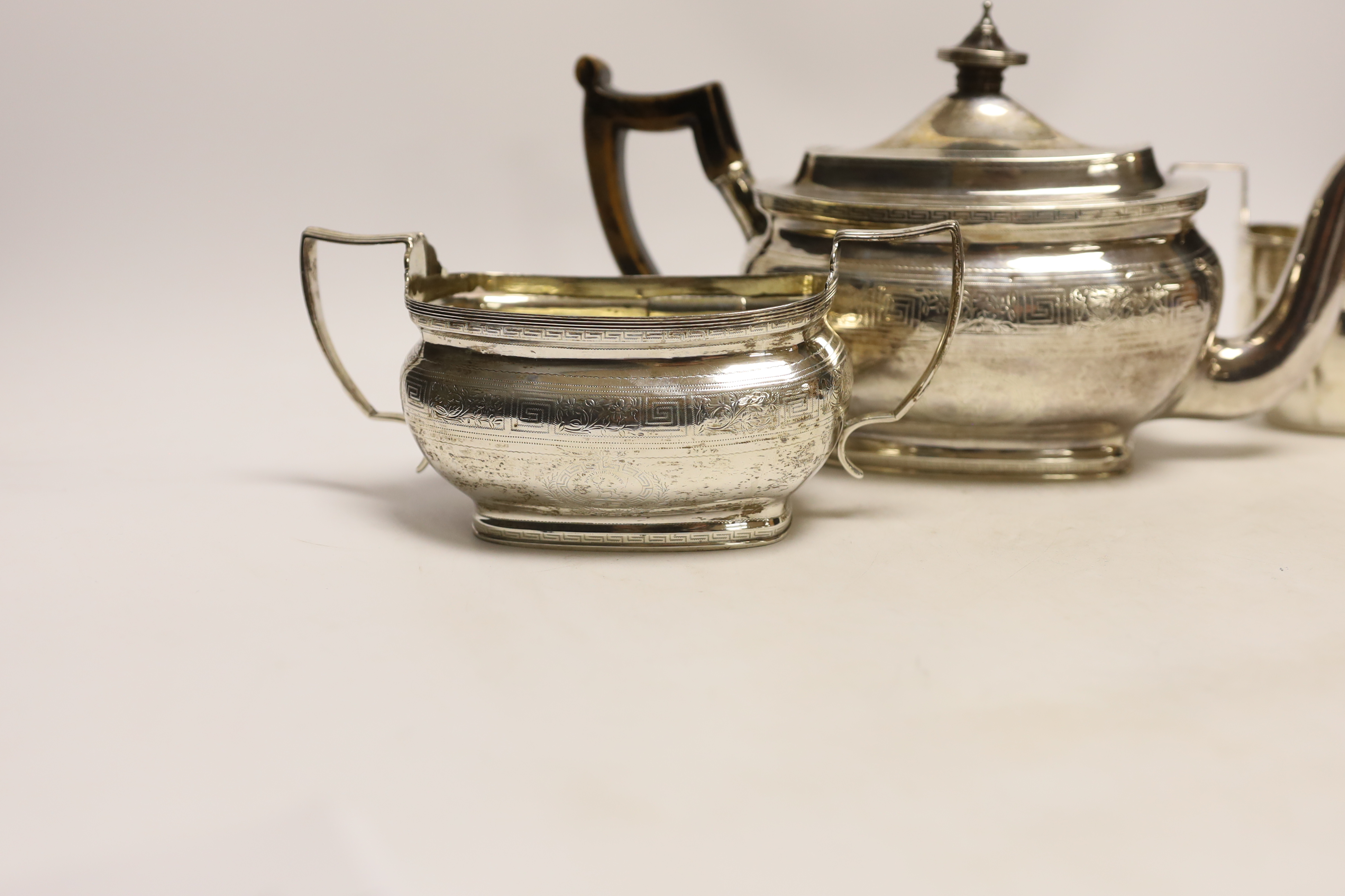 A George III engraved silver teapot and sugar bowl, by Andrew Fogelberg, London, 1805 and a similar matched silver cream jug, maker's mark rubbed, London, 1806